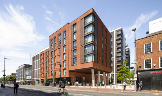 Contemporary residential building with street-level activity.